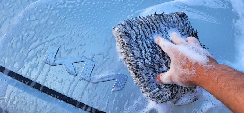 Decontamination wash being carried out on KIA EV3 bonnet
