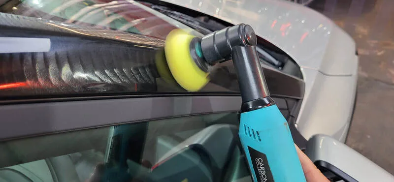 Gloss black panel being machine polished in Paisley at DMD Car Detailing