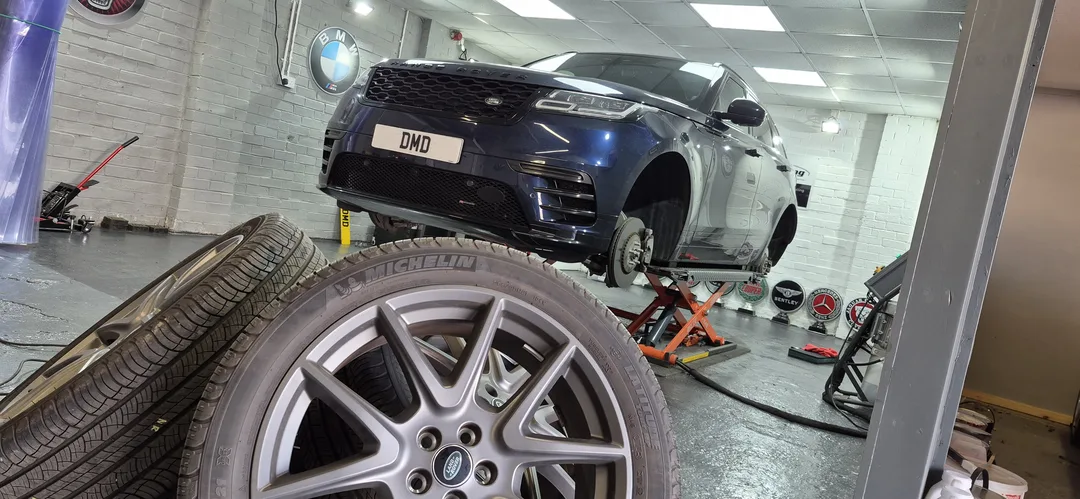 Range Rover Velar with wheels removed before fully cleaning for ceramic coating treatment