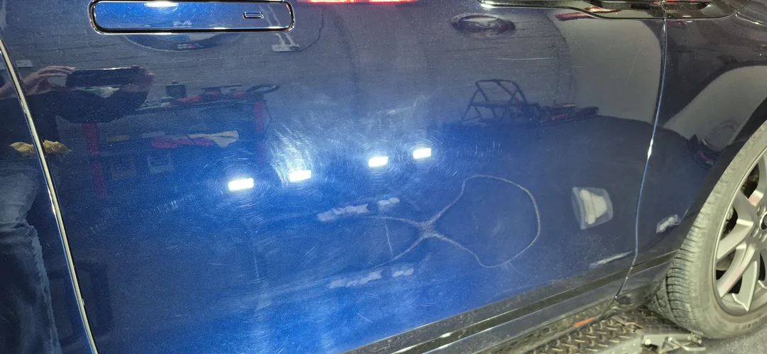 Portofino Blue Range Rover Velar P400 before paint correction, swirl marks visible under workshop lighting