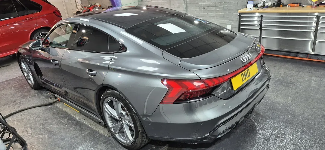 Audi e-tron GT rear view showing corrected, glossy Daytona Grey finish