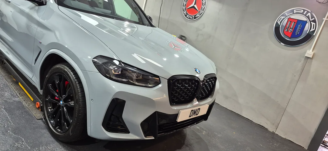 Bonnet on this BMW X4 looking glossy after being ceramic coated in Paisley at DMD Car Detailing