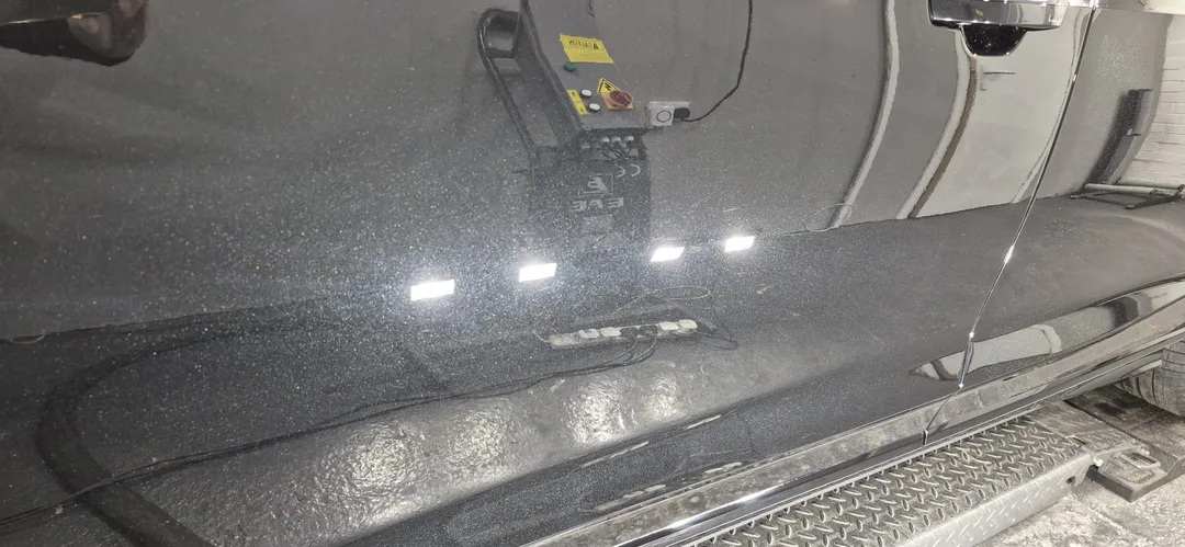 Close-up of corrected Mythos Black Metallic paintwork on Audi A8 door panel